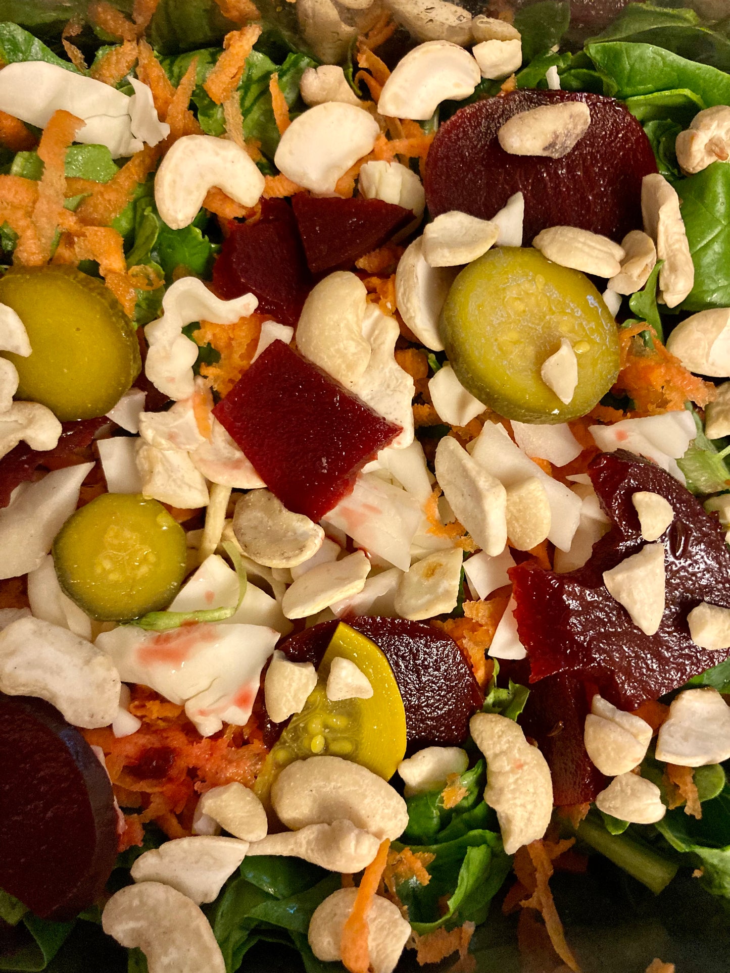 Fed Up Foods Kickin Pickled Beet with curried pickled zucchini on a salad with cashews and spinich